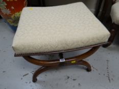 An antique mahogany X-frame footstool (upholstered to match lot 106)