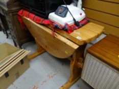 A drop leaf pine dining table