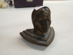 A cast metal bust of a Native American Indian (probably a finial from a gaming machine)