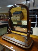 An antique mahogany toilet mirror