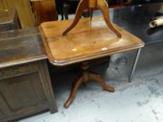 An antique Victorian mahogany tilt-top tripod table