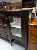 A vintage single-door cabinet with two internal shelves