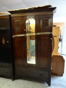 A vintage mahogany single-door wardrobe with carved detail on base drawer