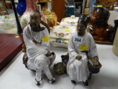 Two Chinese stoneware & glazed decorated seated figures