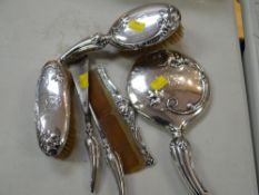 A good six-piece silver backed dressing-table set, each piece with relief decorated lion with art