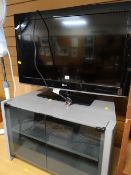 A parcel of modern lounge furniture including desk, shelving,a baize lined folding card table