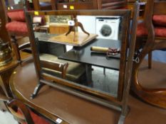 An antique inlaid mahogany toilet mirror