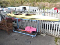 A two-person fibre glass kayak canoe with paddles etc (outside)