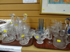 Two trays of various glassware including cut glass decanters, jugs etc