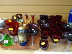 Collection of mainly red glass items including drinking glasses, jugs etc