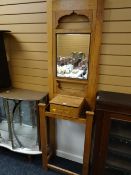 A narrow vintage oak mirror back hall stand