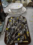 A tray of various flatware, napkin rings, serving spoons etc