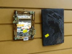 A small mirror with frame designed by Cardiff artist Elizabeth 'Betty' Lewis and a small relief