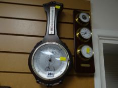 A modern wooden banjo thermometer barometer together with a modern three-section barometer clock