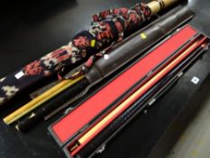 A hard cased two-piece snooker cue together with a leather cased pair of snooker cues & a