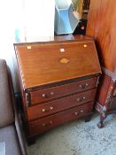 An Edwardian inlaid mahogany three-drawer sloped front bureau