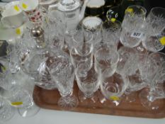 A heavy quality cut glass single-handled circular based decanter with part silver stopper & a