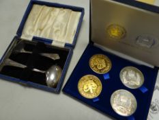 A cased four-piece Queen Elizabeth II commemorative coin set & a cased pusher & spoon set
