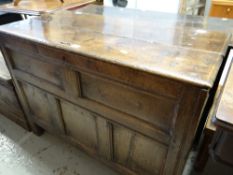 An early nineteenth century panelled oak blanket chest