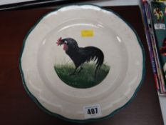 A believed Llanelly pottery Black Cockerel plate with retailer stamp T Goode & Co of London to reve