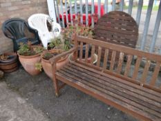 A parcel of garden items including wooden bench, table, plastic chairs, potted plants, water