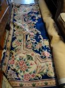 A large Chinese washed blue floral carpet