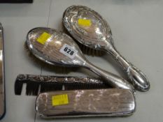 A parcel of silver backed dressing table items with various patterns