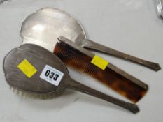 Three machine turned silver backed dressing table items
