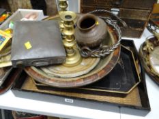 Two ebonized wooden trays, brass charger, candlesticks etc