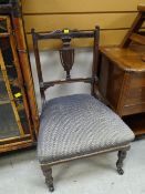 An Edwardian nursing chair with campana back