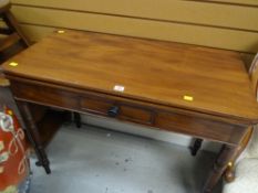 An antique mahogany foldover tea table with single centre drawer