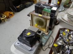 Boxed alarm clock, vintage cameras, mantel clock, boxed coasters, wooden candlesticks, parcel of