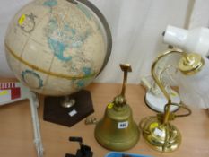Vintage world globe on a stand, possibly ship's bell and two table lamps