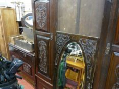 Carved fronted Edwardian wardrobe with centre oval bevelled mirror and base drawer, matching