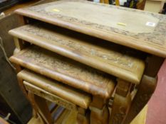 Carved nest of four coffee tables