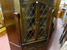 Polished floorstanding corner cupboard with upper leaded glass doors
