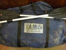 Cased Yam inflatable boat with a pair of oars