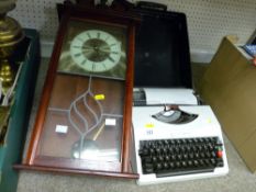 Modern pendulum wall clock and an Imperial 205 portable typewriter