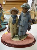 A Lladro model of two children walking hand in hand in winter clothes, inscribed no.2242 to the