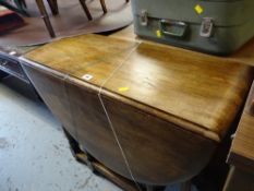 A vintage oak drop-leaf gate-leg dining table