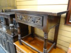 A reproduction carved oak side table