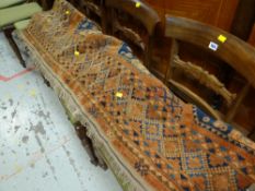 An antique rust coloured Persian carpet