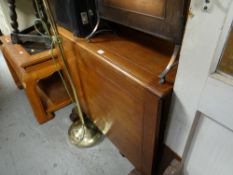 A vintage light oak drop leaf dining table