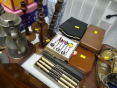 A parcel of cased cutlery, turned candlestick holders etc
