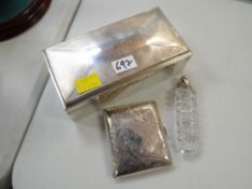 Machine turned sarcophagus shaped silver cigarette box, a chased silver cigarette case & silver