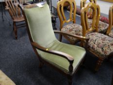 A carved antique button upholstered library armchair