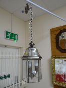 A modern lantern-style drop ceiling light
