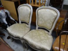 A pair of reproduction white painted wood French-style salon chairs with upholstered seat & backs