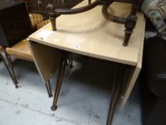 A retro-cool American Daystrom Formica topped drop leaf with twin metal legs table together with