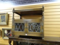 A Jacobean-style reproduction TV cabinet